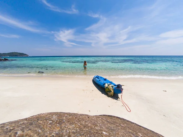 woman with a kayak on an isolated beach in Andaman sea, Koh Lipe