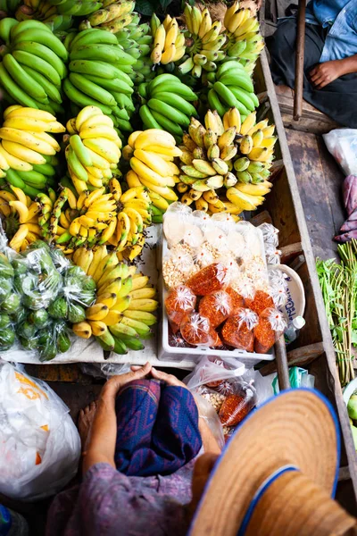 floating market - top view of boat full of fresh fruits on sale