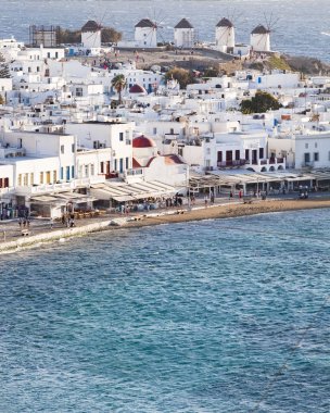 panoramic view of the Mykonos town harbor with famous windmills  clipart