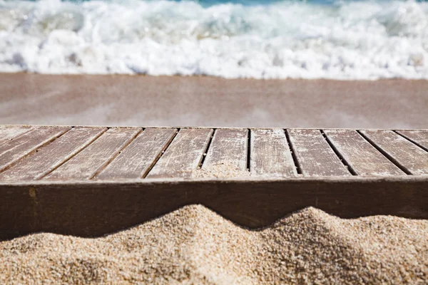 Tablón de madera en arena y mar azul en el fondo —  Fotos de Stock