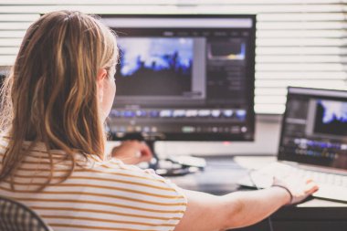 woman daydreaming while working on laptop in home office, social media influence 