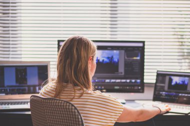 woman daydreaming while working on laptop in home office, social media influence 