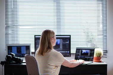 woman daydreaming while working on laptop in home office, social media influence 