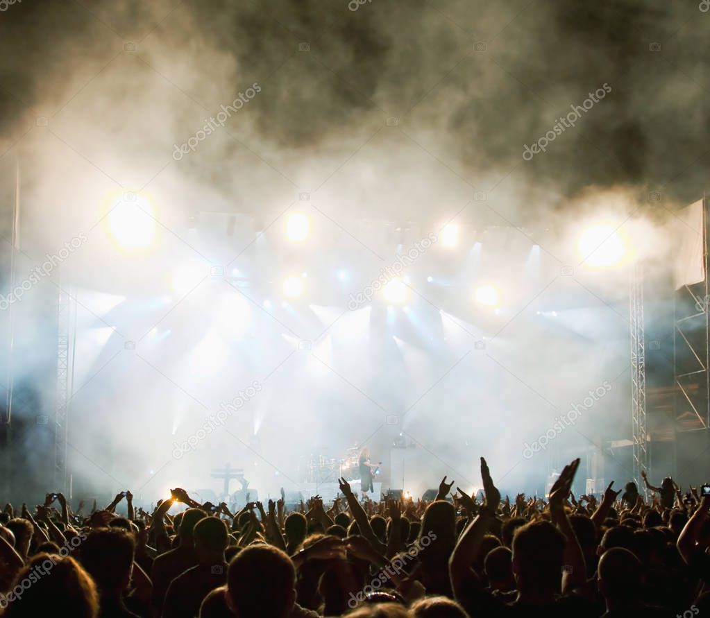 crowd at concert and stage lights with space for text