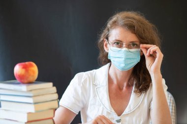 back to school during covid pandemics teacher with face mask clipart