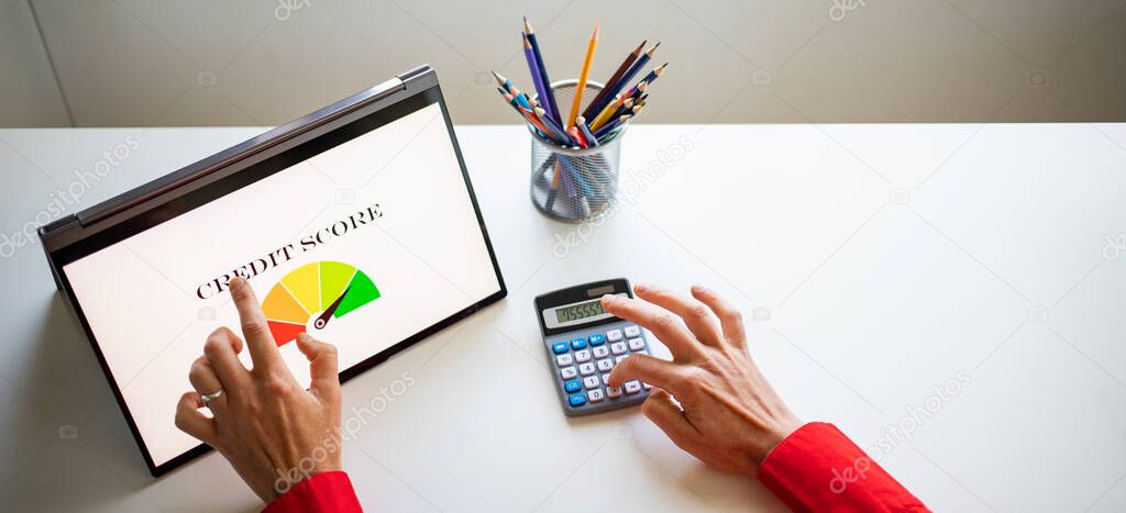 online finances hand pressing credit score button on tablet
