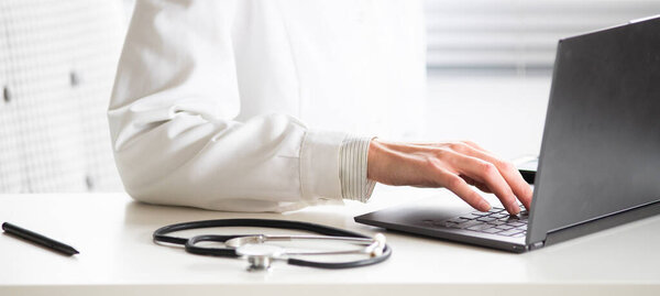 hands of doctor working on laptop tele medicine concept