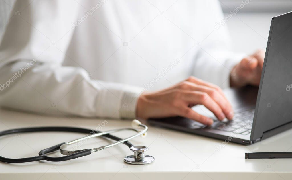 hands of doctor working on laptop tele medicine concept