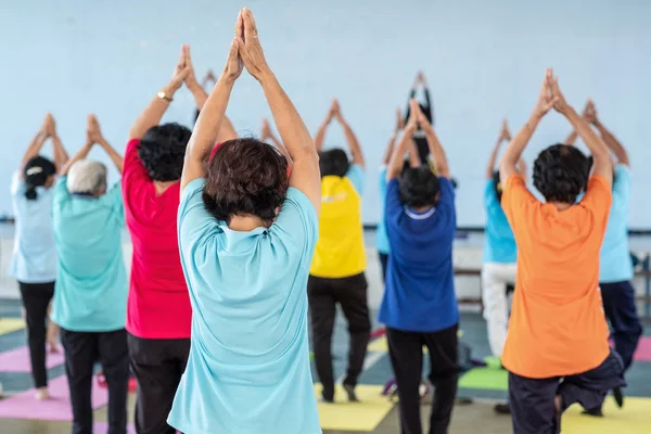 back side of senior-age in yoga class room