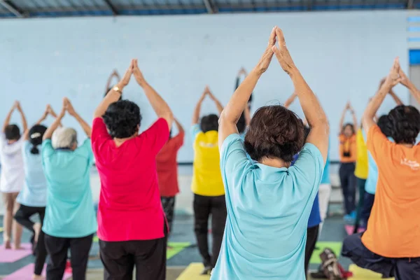 back side of senior-age in yoga class room