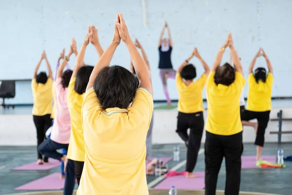 Elderly in a yoga exercise posture