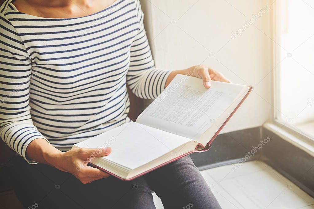 Woman is reading and praying over bible