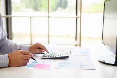 Business adviser analyzing financial figures denoting the progress Internal Revenue Service checking document. Audit concept