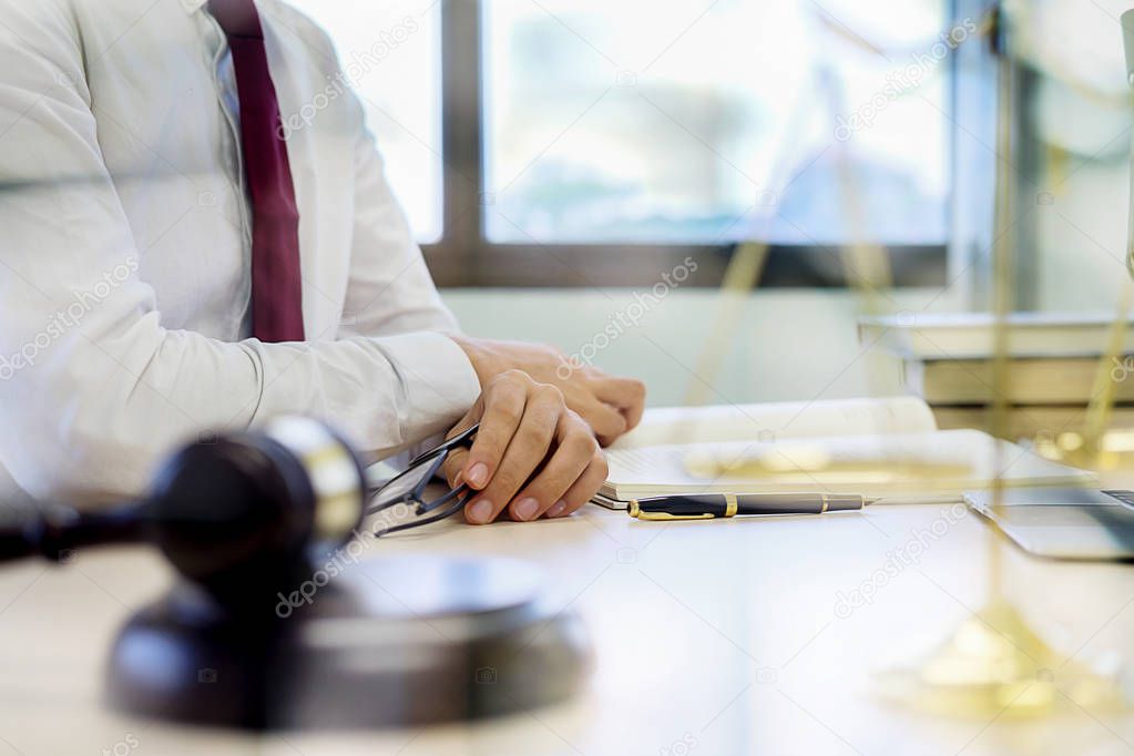 Judge gavel with Justice lawyers having team meeting at law firm in background. Concepts of law.