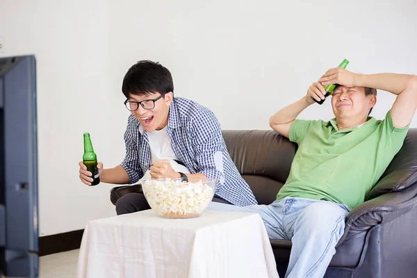 People watch soccer. Asian football supporters watching soccer o