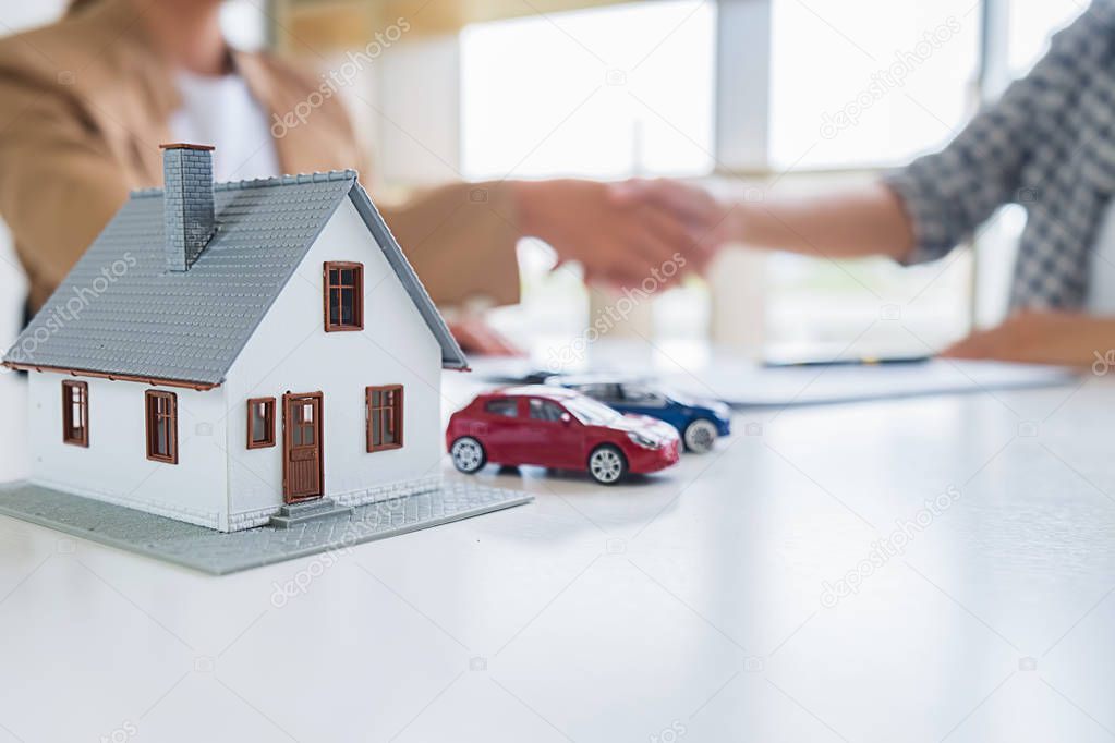 Real estate agent shaking hands with customer for deal contract 