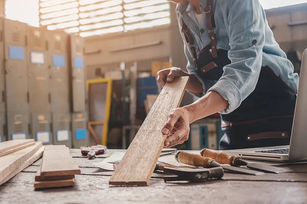 Tischler arbeitet mit Geräten auf Holztisch in Tischlerei — Stockfoto