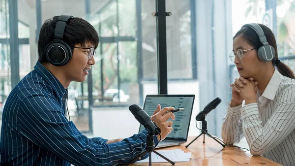 Young business people recording a podcast in a studio