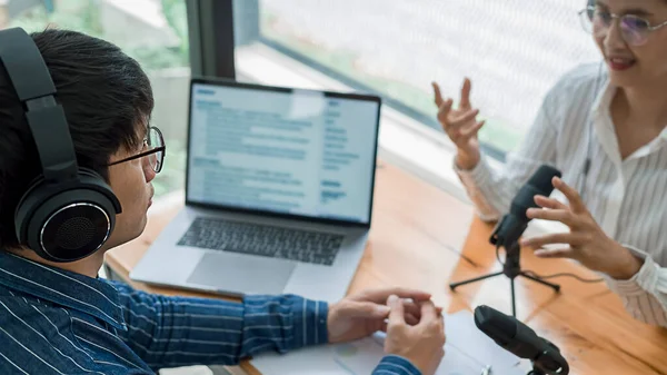 Young business people recording a podcast in a studio