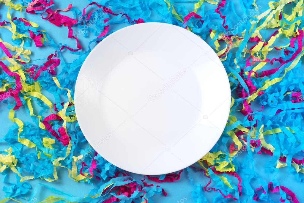 Decorative abstract background of colored paper on a blue background white plate on blue background
