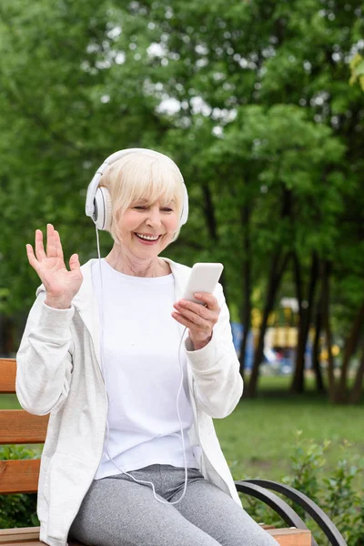 Cheerful Elderly Woman Listening Music Headphones Smartphone Park — Stock Photo, Image