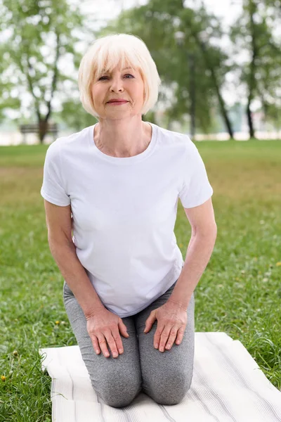 Wanita Senior Berlatih Yoga Atas Tikar Halaman Hijau — Foto Stok Gratis