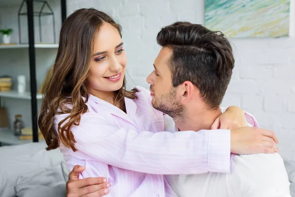 Attractive Girl Hugging Her Handsome Boyfriend Bedroom — Free Stock Photo