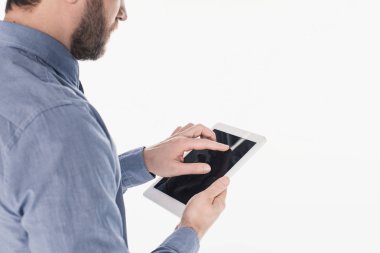 partial view of bearded man using tablet with blank screen isolated on white
