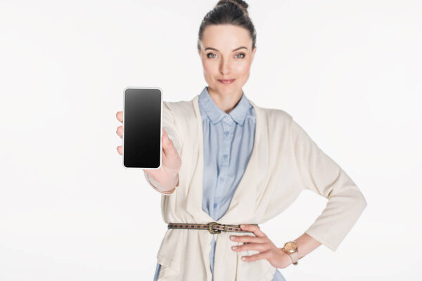 portrait of woman showing smartphone with blank screen isolated on white