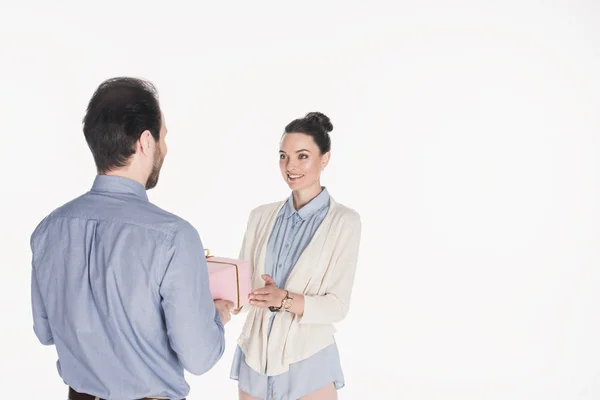 partial view of man presenting wrapped gift to smiling wife isolated on white