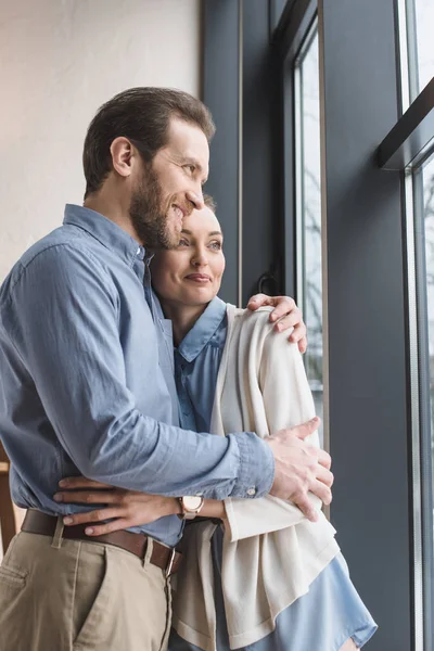 Portrait Beautiful Smiling Couple Hugging Each Other Looking Out Window — Stock Photo, Image