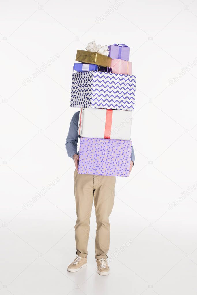 obscured view of man holding pile of wrapped gifts in hands isolated on white