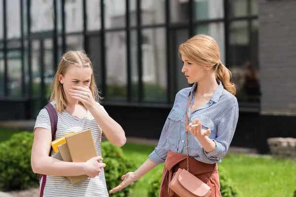 Tiener Dochter Bedekking Neus Terwijl Haar Moeder Roken Sigaret — Stockfoto