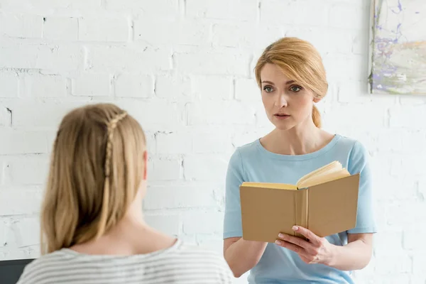 Mother Book Standing Daughter Talking Her — Stock Photo, Image