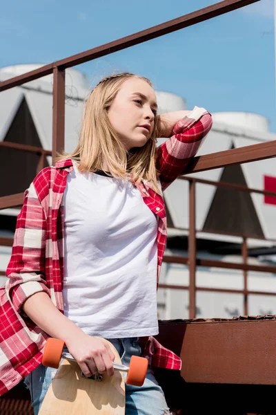 Thoughtful Teen Girl Red Plaid Shirt Skateboard Industrial Background — Free Stock Photo