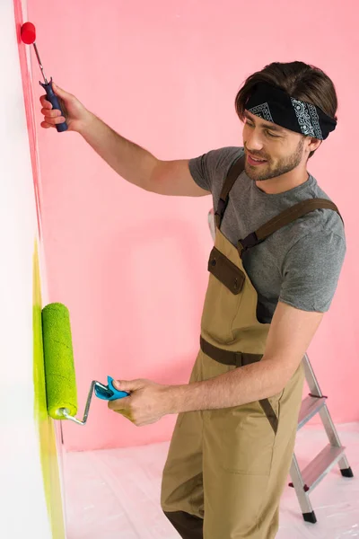 Smiling Man Working Overall Painting Wall Two Paint Rollers — Stock Photo, Image