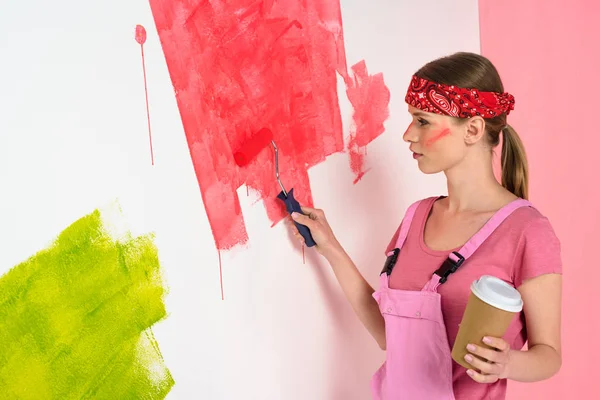 Young Woman Coffee Cup Painting Wall Red Paint Roller — Free Stock Photo