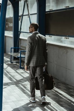Kendine güvenen işadamı toplu taşıma istasyonu üzerinde yürüme