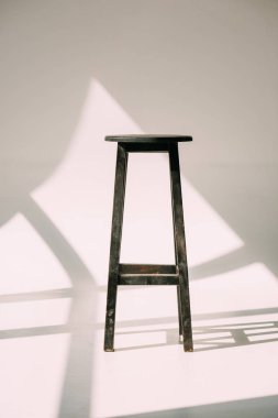 single empty tall wooden stool on white clipart