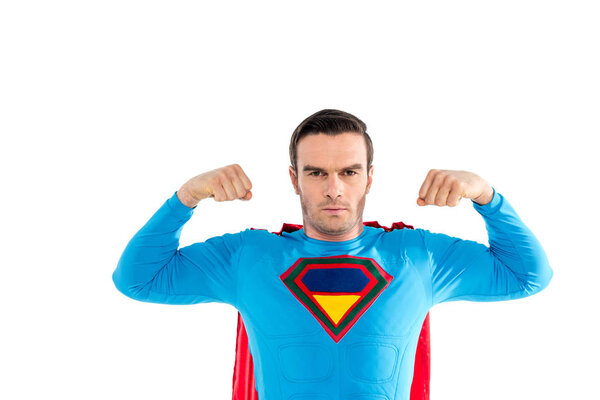 handsome superhero showing muscles and looking at camera isolated on white