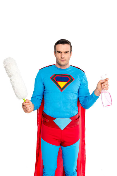 man in superhero costume holding duster and spray bottle isolated on white
