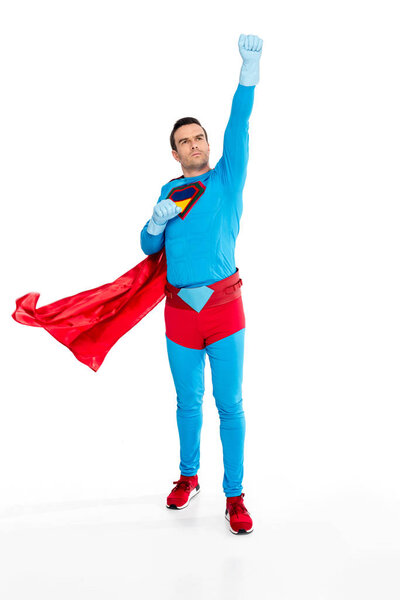 full length view of male superhero in rubber gloves raising hand and looking up isolated on white