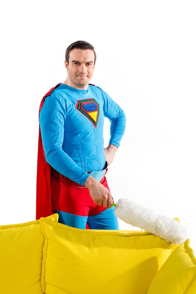 Knappe Mannelijke Superheld Schoonmaken Bank Met Stofdoek Lachend Camera Geïsoleerd — Gratis stockfoto