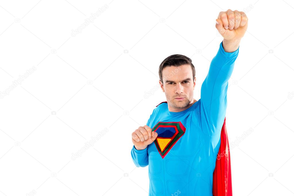 handsome male superhero raising hand and looking at camera isolated on white