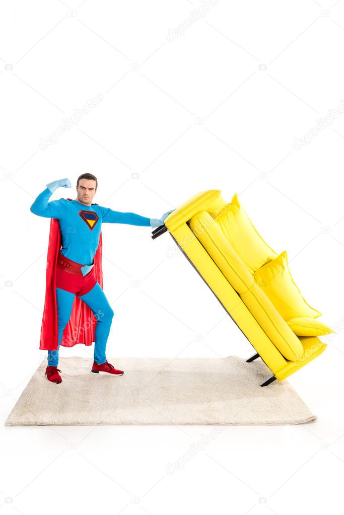 superhero holding couch and showing biceps isolated on white