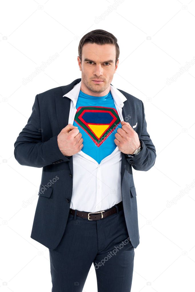 businessman showing superhero costume under suit and looking at camera isolated on white