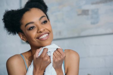 portrait of smiling african american girl in bedroom  clipart