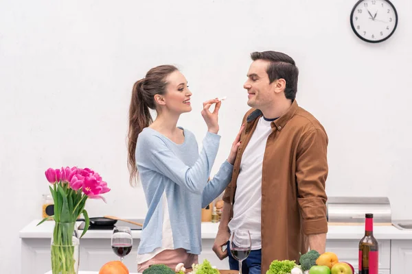 Feliz Mujer Adulta Alimentando Marido Con Setas Durante Preparación Cena — Foto de stock gratis