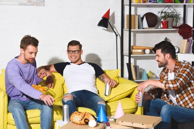 yakışıklı genç erkekler gülümseyen bira içme ve aperatifler evde yemek parti 