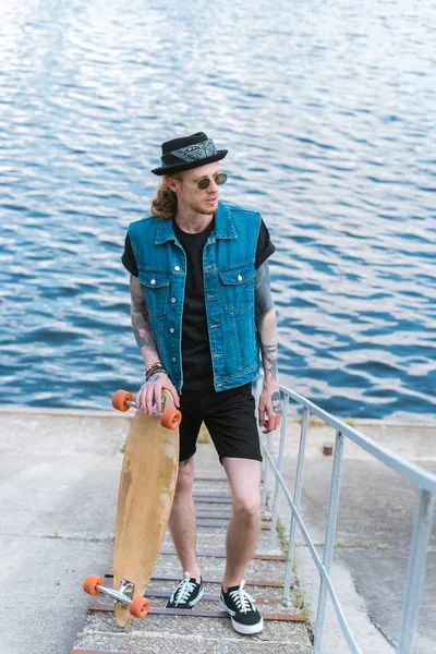 Handsome Stylish Tattooed Man Standing Skateboard Stairs River — Stock Photo, Image